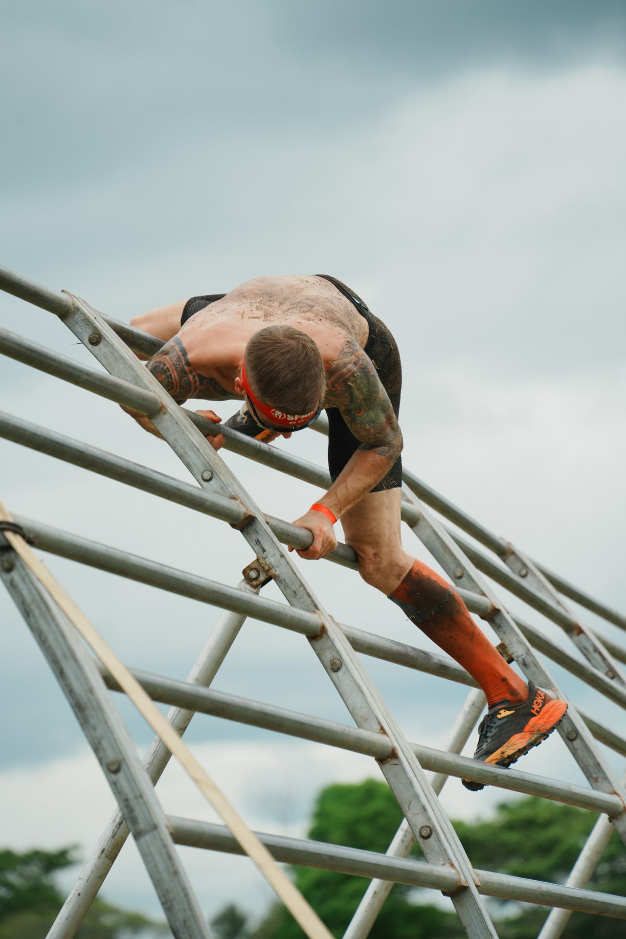 A man climbing up the side of a metal ladder